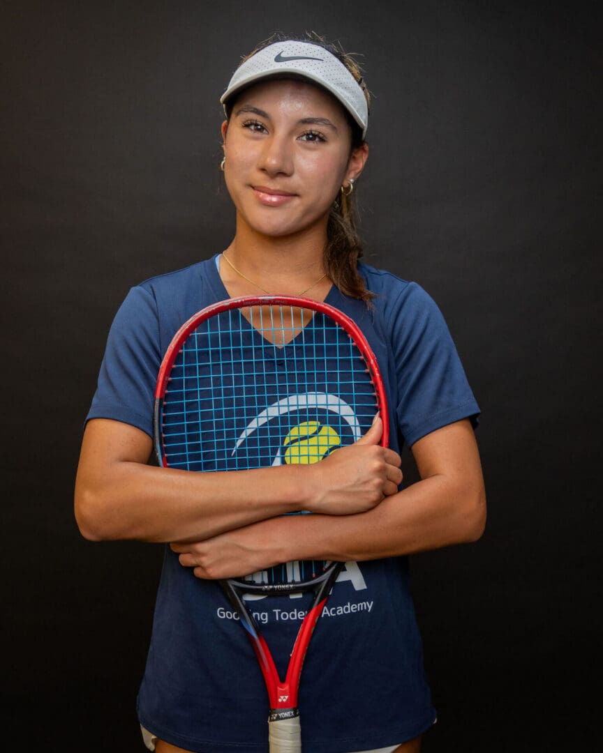 Smiling tennis player holding racket