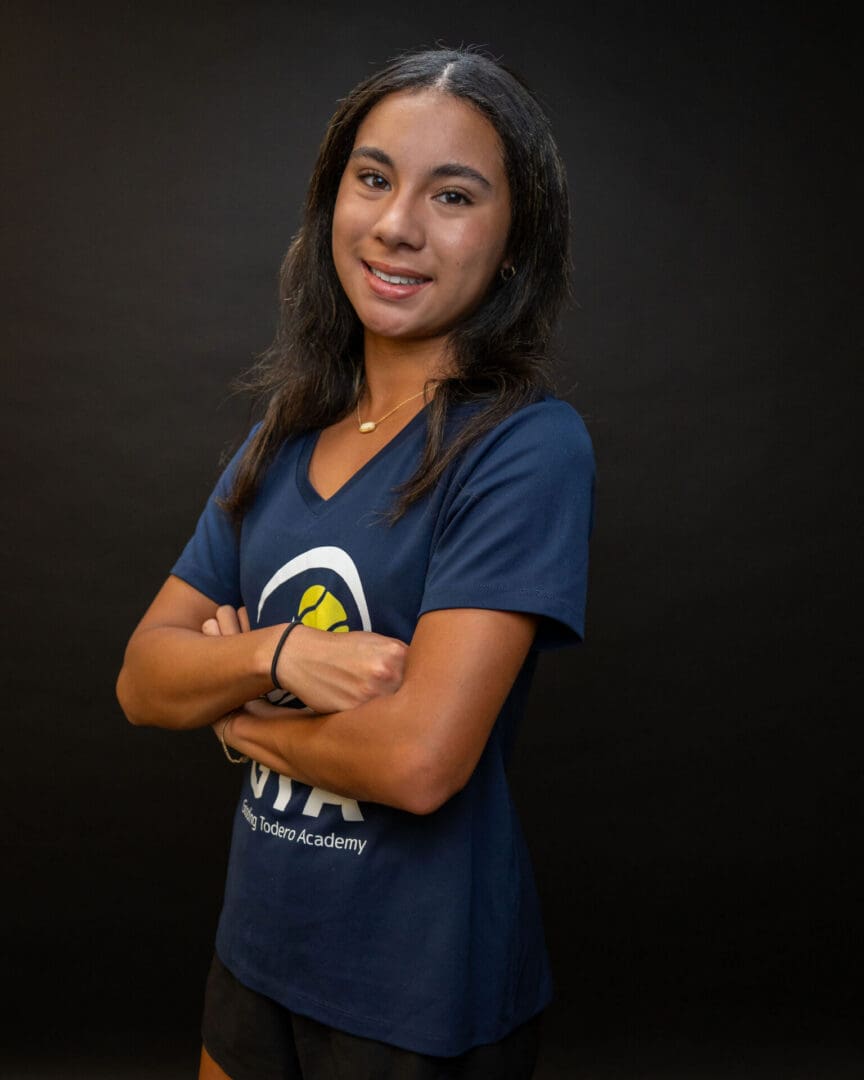 Smiling young woman with arms crossed