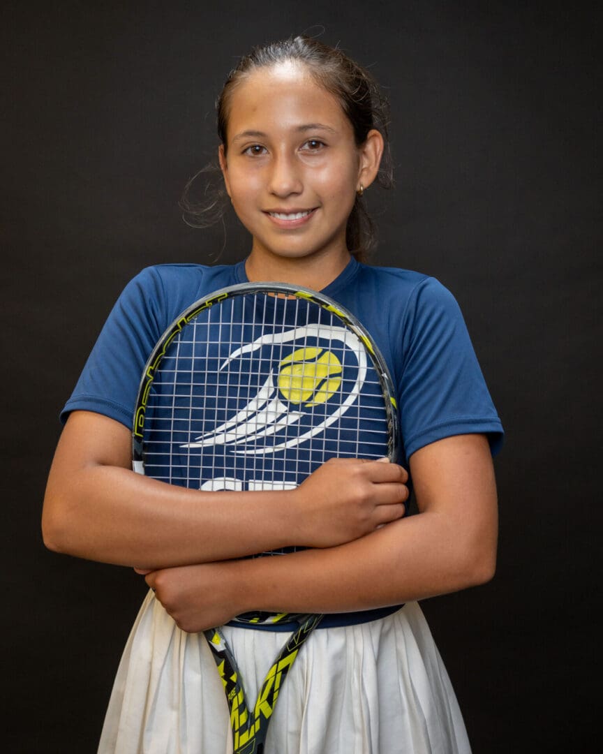 Young tennis player in blue shirt smiling