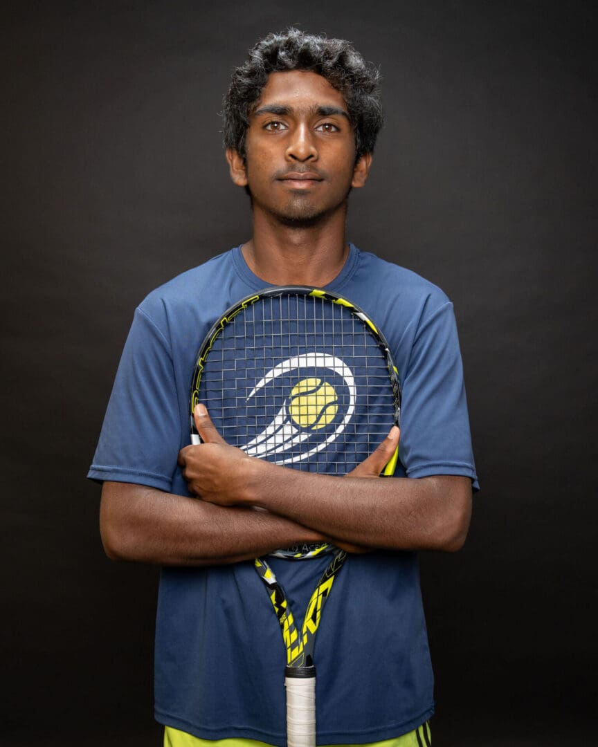 Athlete in blue shirt with tennis racquet