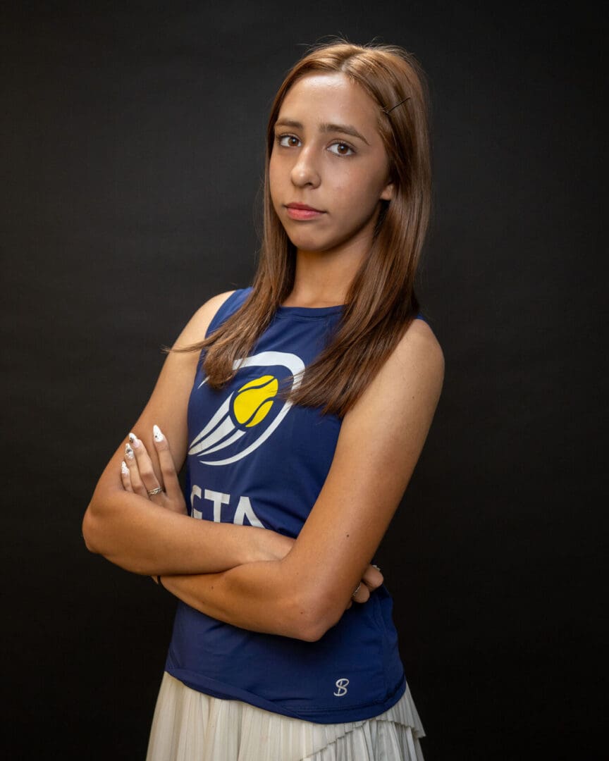 Athlete in blue jersey with arms crossed